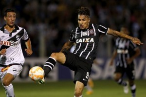 Paolo Guerrero from Brazil's Corinthians controls the ball under pressure from Cristian Gonzalez of Uruguay's Danubio during their Copa Libertadores soccer match in Montevideo